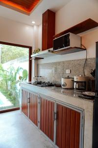 a kitchen with a counter top with a microwave at The Hide El Nido Villas in El Nido