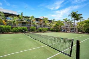 a tennis court in front of a resort at Baden 74 Rainbow Shores in Rainbow Beach