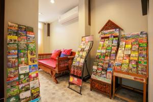 a store with a couch and a chair in a room at Cozy Lanna Hotel in Chiang Mai