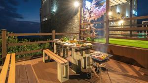 a table with a tray of food on a balcony at Geoje Inbito Pension in Op'o