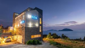 a villa with a sign on the side of a building at Geoje Inbito Pension in Op'o +1 photo