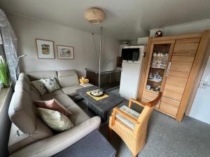 a living room with a couch and a refrigerator at Ferienhaus Fuxbau in Wohlau