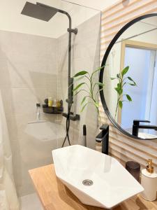 a bathroom with a sink and a mirror at SunCoast terrace apartment in Saulkrasti +18 photos