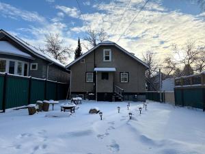 a yard covered in snow in front of a house at Restly an Elegant Home by Whyte Ave in Edmonton