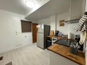 a kitchen with a refrigerator and a counter top at Restly an Elegant Home by Whyte Ave in Edmonton