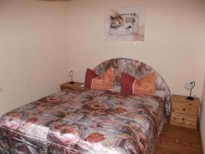 una camera da letto con un grande letto con cuscini rossi di Ferienhaushälfte Lütow a Lütow