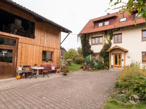 a courtyard of a house with a table and chairs at Haus Wollmeister in Bad Liebenzell