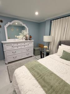 a bedroom with a white dresser and a mirror at Private Paradise bk in Brooklyn +16 photos