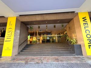 a lobby of a building with stairs in front at Trigo Hotel Kuala Lumpur in Kuala Lumpur