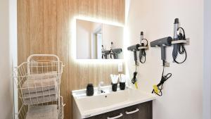 a bathroom with a white sink and a mirror at LAZULI Fukutsu in Fukuoka +49 photos