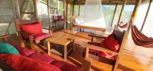 a room with a couch and chairs and a hammock at The Amazing Villa in Anepahan +66 photos