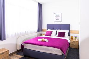 a bedroom with a bed with a teddy bear on it at Apartments R Sport boutique with free Parking in Sarajevo