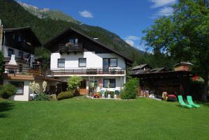 a large white house with a lawn in front of it at Ferienhaus Pernull in Hermagor