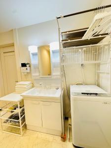 a small kitchen with a sink and a dishwasher at 楽途居 in Osaka