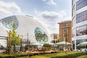 a rendering of a domed building with people sitting outside at Spacious Family Stay Eindhoven, Garden & Kitchen in Eindhoven