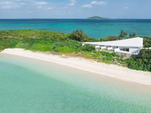 an aerial view of a building on a beach at VOYAN Resort MiyakojimaーAZOMARE アゾマーレ in Miyako-jima