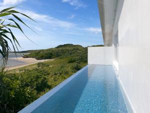 a swimming pool with a view of the beach at VOYAN Resort MiyakojimaーAZOMARE アゾマーレ in Miyako-jima +60 photos