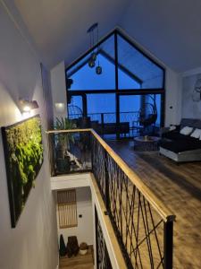 a living room with a balcony with a large window at Vrh house in Ravna Gora