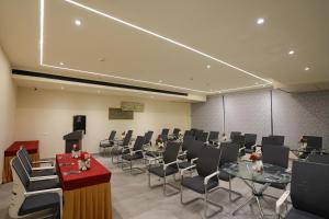 a conference room with tables and chairs and a podium at Town Square Suites in Hyderabad +20 photos