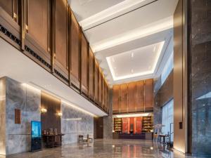 a lobby of a building with wooden walls and ceilings at Maison New Century Ninghai Railway Station in Ninghai