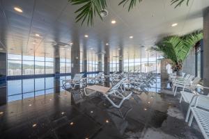 a cafeteria with white chairs and tables in a building at Chestertons Gyeongju in Gyeongju