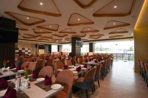 a dining room with tables and chairs with purple flowers at Town Square Suites in Hyderabad