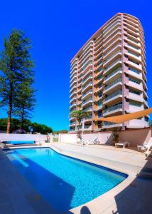 a large building with a swimming pool in front of a building at Narrowneck Court Holiday Apartments in Gold Coast