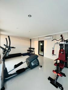 a gym with two treadmills and a treadmill at Prajan Residence in Buriram