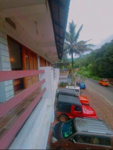 two cars parked on the side of a building at PERIYAR Paradize Inn,Kumily in Thekkady