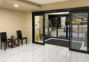 a room with glass doors and a table and chairs at Comfort Suites Kings Bay Naval Base Area in Kingsland