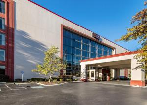 a building with a parking lot in front of it at Clarion Hotel Jackson Northwest in Jackson