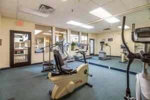 a gym with treadmills and machines in a room at Clarion Hotel Jackson Northwest in Jackson