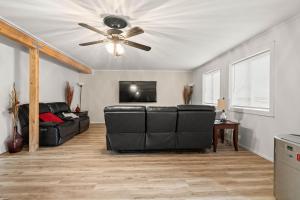 a living room with a ceiling fan and a couch at 4-Bedroom Chateau in Southern Washington- Luxurious Retreat with Pond & Creek in Amboy