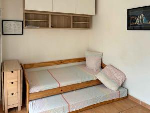 a small bedroom with a bed and a cabinet at Orangeraie du Cap d'Antibes in Antibes