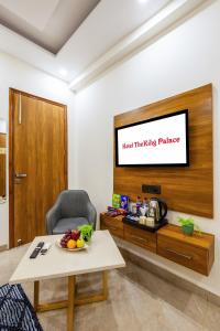 a living room with a flat screen tv on a wall at Hotel The King Palace Free Pick up From Nizamuddin Railway Station in New Delhi