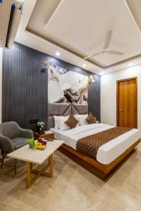 a bedroom with a large bed and a table at Hotel The King Palace Free Pick up From Nizamuddin Railway Station in New Delhi +91 photos