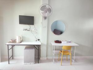a room with a desk and a mirror and a table at Banyai Pool Villa Chiang Khan in Loei