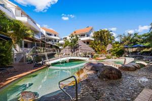 a swimming pool in a resort with a resort at Noosa International Resort in Noosa Heads