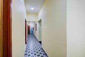 a hallway with blue tile flooring in a hallway at Hotel O Puri Seaview Formerly Sea Star in Puri