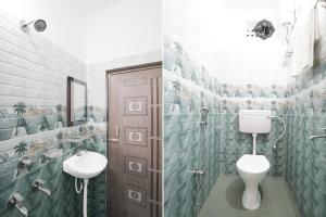 a bathroom with a toilet and a sink at Hotel O Puri Seaview Formerly Sea Star in Puri