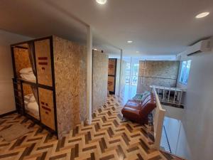 a room with a room with bunk beds and a staircase at Sleep On The Clouds in Ban Kata