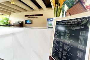 a restaurant counter with a menu on the wall at Alta Cebu Resort Mactan powered by Cocotel in Mactan