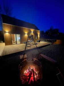 a fire pit in front of a building at night at Gawra Pogórze in Jawornik Polski