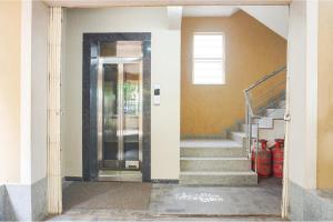 a hallway with stairs and a glass door at Via Shree Haree Residency in Pune