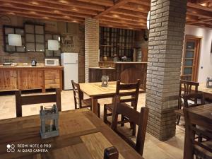 a kitchen with wooden tables and chairs in a room at Private Room close to Beautiful Parma in Montechiarugolo