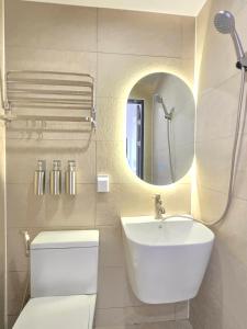 a bathroom with a sink and a toilet and a mirror at Quantum Hotel, Seoul Station br in Seoul +52 photos