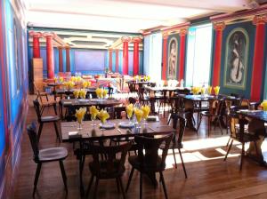 a restaurant with tables and chairs in a room at Couvent de Saint-Ulrich in Sarrebourg