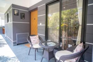 a patio with a table and chairs and a balcony at Luho Aarambha in Bangalore