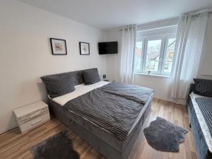 a bedroom with a large bed and a television at Romantica in Rust