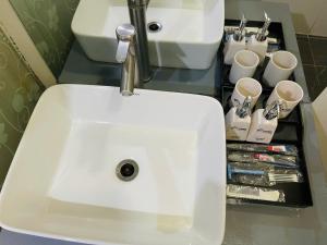 a white sink with a faucet in a bathroom at Home Villa TP Giao Lưu in Hanoi